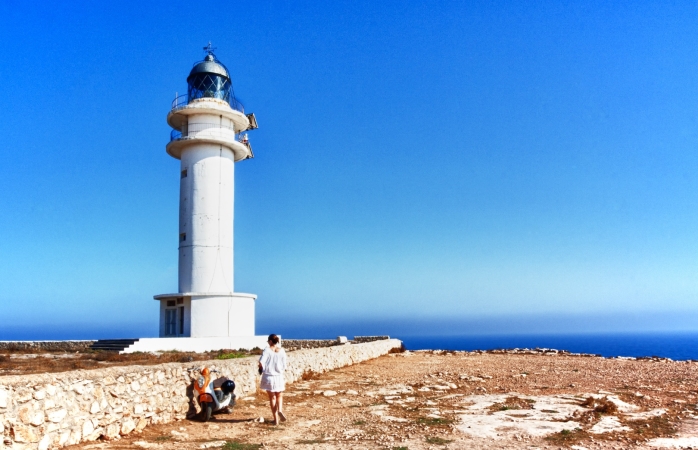Break the trend: 7 original alternatives to the classic Spanish destinations İspanya'da gezilecek yerler- Formentera Deniz Fenerini gezen bir kadın.