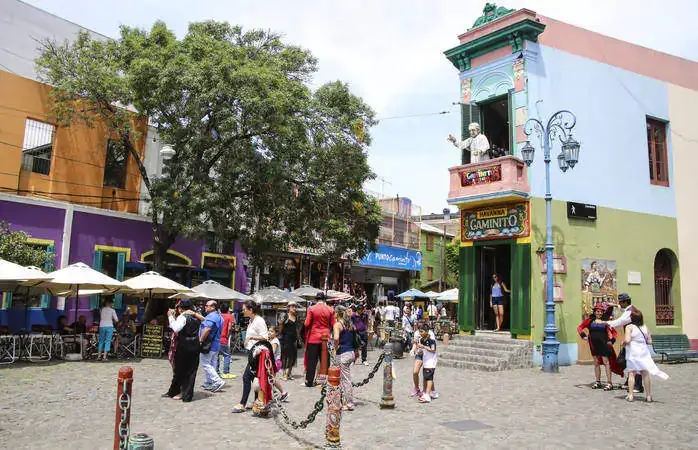 Buenos Aires, Argentina - January 26, 2015: tango dancer pose for tourists in Caminito Street, Buenos Aires, Argentina. Caminito is a traditional alley, located in La Boca.