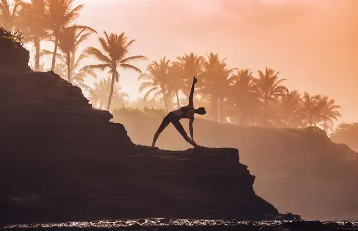 Indonesia, Bali, woman practising yoga at the coast at twilight