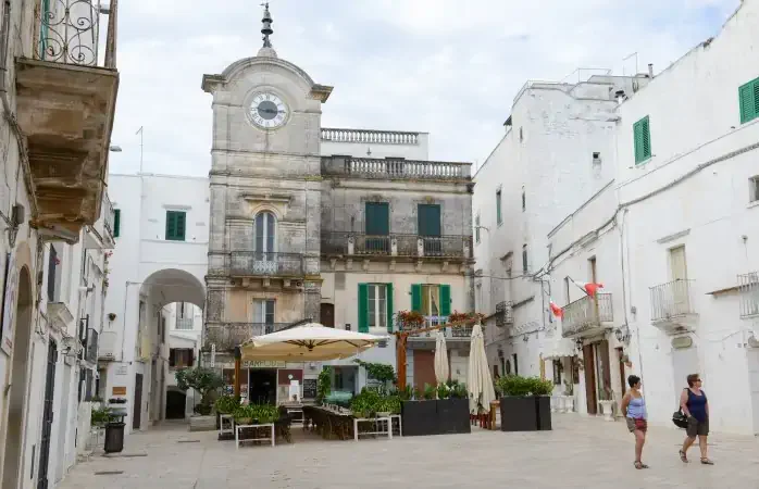 Cisternino, Italy - 25 June 2016: people walking on the main square of Cisternino on Puglia, Italy