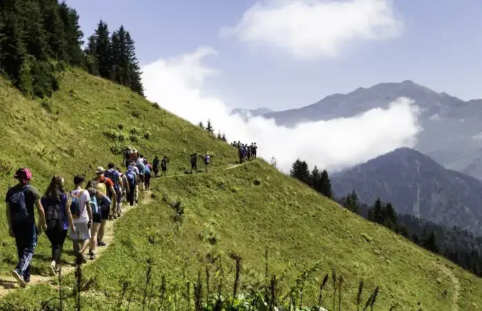 SENYUVA, CAMLIHEMSIN, RIZE, TURKEY - AUGUST 29, 2016: A group of hikers climbs along the trail in the Pokut plateau around Kackar mountains, Camlihemsin. Camlihemsin is a small town and district of Rize Province in the Black Sea region of Turkey.